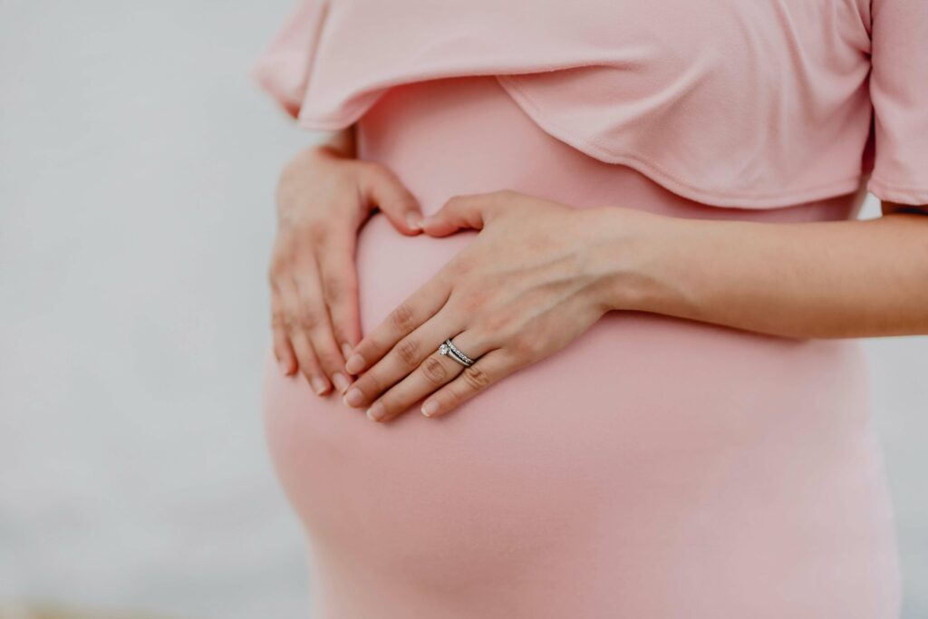 pregnant woman with hands over stomach